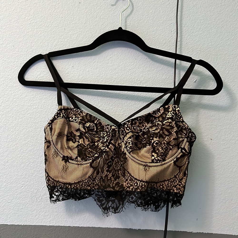 Tan with black lace crop top, zipper back and has under wire, size medium